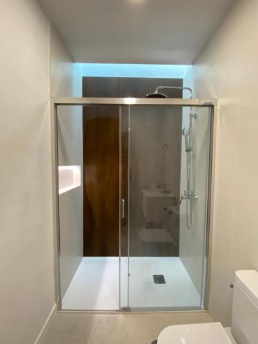 a bathroom with a glass shower with a toilet at Casa Ma in Guatiza