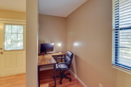 a room with a desk with a computer and a chair at Lake Days and Golf Outings Summerfield Group Escape in Summerfield