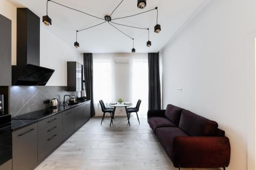 a living room with a couch and a table at Luxury Apartments Laborca in Uzhhorod