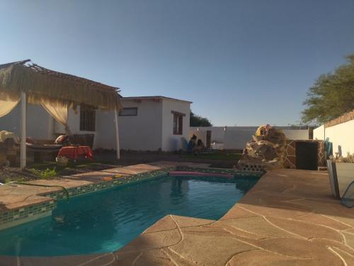 a swimming pool in the backyard of a house at Cabañas Voyage Atacama in San Pedro de Atacama