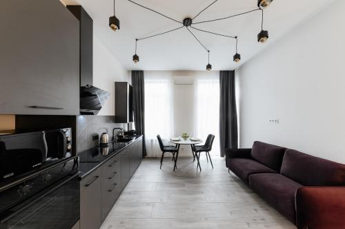 a living room with a couch and a table at Luxury Apartments Laborca in Uzhhorod
