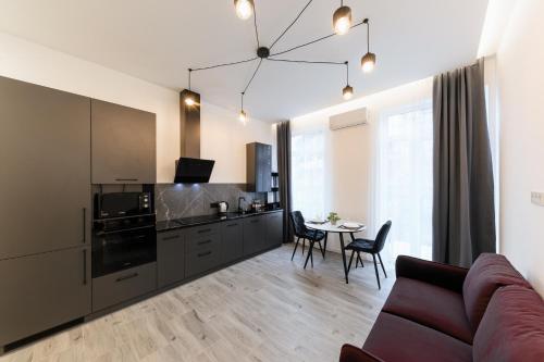 a kitchen and living room with a couch and a table at Luxury Apartments Laborca in Uzhhorod