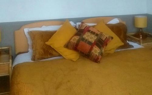 a bed with a bunch of pillows on it at Jesmond B&B Kingsize Ensuite Room 2 in Hull