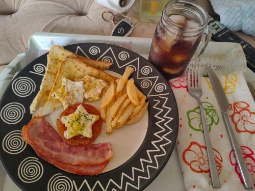 a plate of food with a sandwich and french fries at Lerato's in Vanderbijlpark