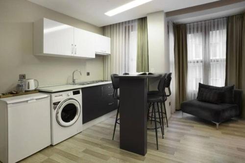 eine Küche mit Waschmaschine und Trockner im Zimmer in der Unterkunft Osmanbey Metrosuna 1 Dk. in Istanbul