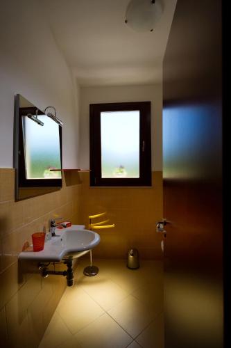 a bathroom with a sink and a window at Al Cantuccio in Castelluzzo