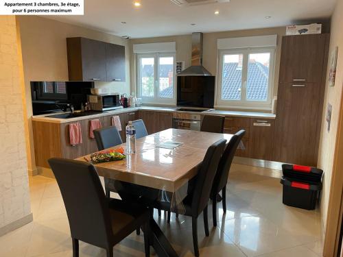 a kitchen with a wooden table and chairs at Appartements centre ville Colmar 4 familles in Colmar