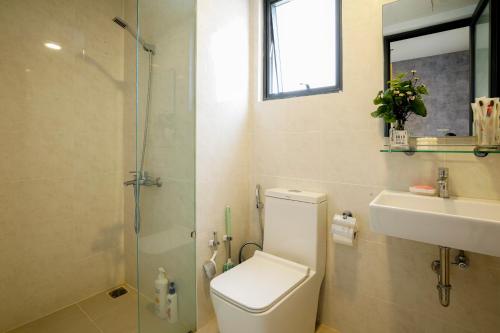 a bathroom with a toilet and a sink and a shower at Tony Apartment Soho Q1 in Ho Chi Minh City