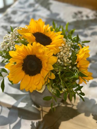 a bouquet of yellow flowers in a vase on a table at Bengiorne! Casa Ginestra in Raiano