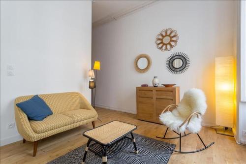 a living room with a couch and a chair at Patchwork - Location meublé T2 - Lyon 2 in Lyon