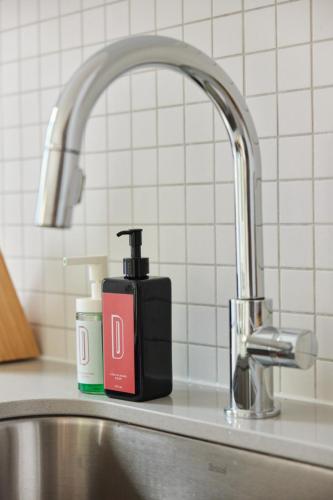 a soap dispenser sitting next to a kitchen sink at New and Cozy 3 bedroom in Le Plateau by Denstays in Montréal