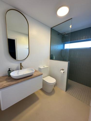 a bathroom with a sink and a mirror and a toilet at Atlantic Corner in Yzerfontein