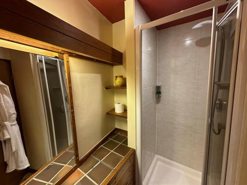 a bathroom with a shower and a glass shower backdoor at High Trenhouse in Settle