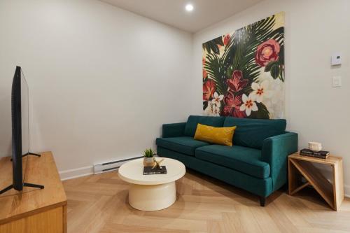 a living room with a blue couch and a tv at Spacious 2 bedroom apartment in Le Plateau by Denstays in Montréal