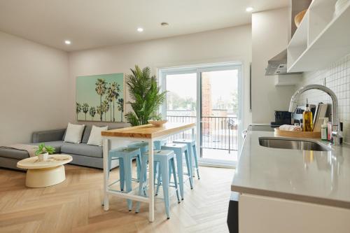 a kitchen and living room with a table and chairs at Urban Gem in Le Plateau by Denstays in Montréal
