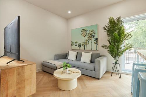 a living room with a couch and a tv at Urban Gem in Le Plateau by Denstays in Montréal