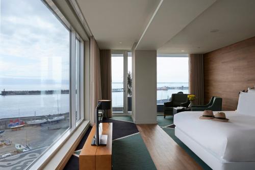 a bedroom with a bed and a large window at Octant Ponta Delgada in Ponta Delgada