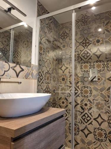 a bathroom with a white sink and a shower at Mansarda di charme con Vista in Turin