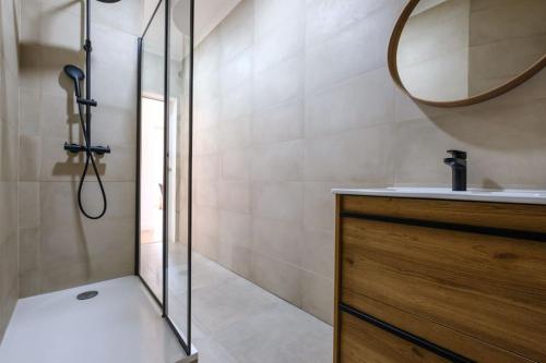 a bathroom with a shower and a sink and a mirror at Apartamento T3 em Lisboa/ Queluz in Queluz