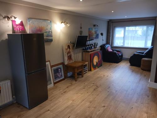 a living room with a refrigerator and a couch at Airbnb Guesthouse in Athlone