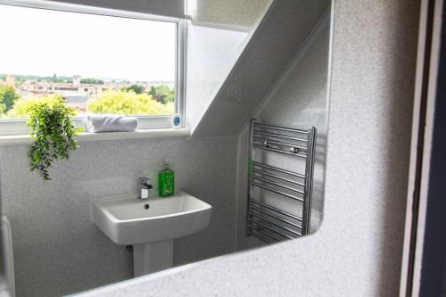 a bathroom with a sink and a window at Bootle, Liverpool Trendy 1Bed Ft in Liverpool