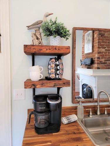 a kitchen counter with a shelf next to a sink at Kelley House in Pensacola