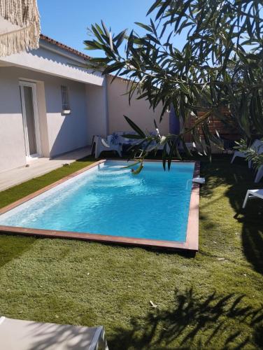 une piscine dans une cour à côté d'une maison dans l'établissement villa Pinarello, à Pinarellu