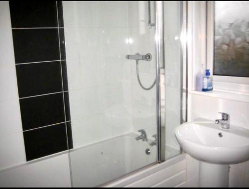 a bathroom with a shower and a sink at Rosanne's Rest in Stevenage