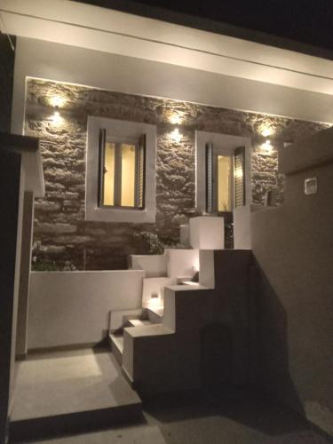 a set of stairs in a room with lights at Angelouda's House in Karistos