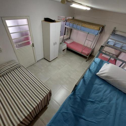 a room with two bunk beds in a room at Hostel Muarama in Passos