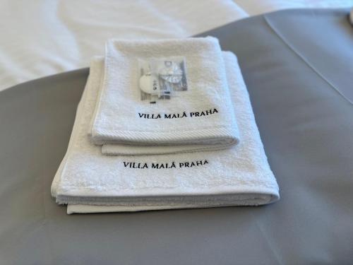 a couple of towels sitting on top of a table at Villa Mala Praha Experience in the Center of Žilina in Žilina
