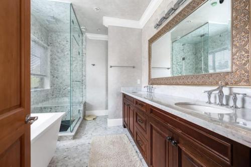 ein Bad mit einem Waschbecken, einer Dusche und einem Spiegel in der Unterkunft No. 2温哥华市中心舒适优雅独立卫生间大床套间 in Vancouver