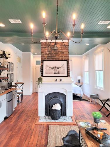 a living room with a fireplace and a chandelier at Kelley House in Pensacola