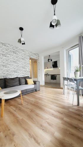 a living room with a couch and a table at Good Time Apartments Strzelecka C in Poznań
