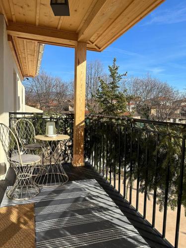a patio with a table and chairs on a balcony at Villa Alma 1910 Starosel in Starosel