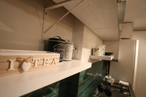 a kitchen with a counter with a shelf with the word i hate at Cassa de Familia in Sarajevo