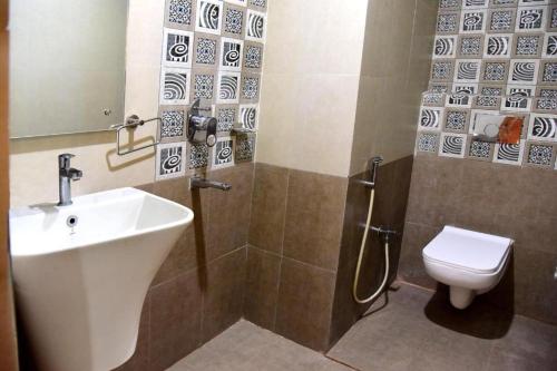 hotel adhunik palace في Keonjhargarh: حمام مع حوض ومرحاض