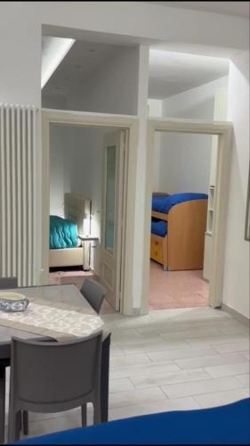 a room with a table and a bedroom with a bed at Dimora Nonna Rosa in Aversa