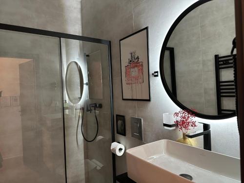 a bathroom with a shower and a sink and a mirror at Villa Mala Praha Experience in the Center of Žilina in Žilina