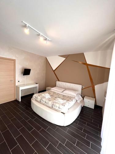 a bedroom with a bed and a tv in it at Berlen Home apartment in Torre Maggiore