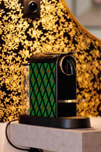 a black and green cell phone sitting on a table at Villa Mala Praha Experience in the Center of Žilina in Žilina