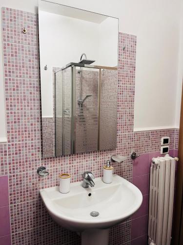 a bathroom with a sink and a mirror at Berlen Home apartment in Torre Maggiore