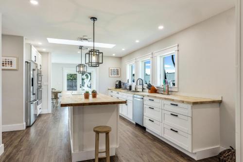 a kitchen with white cabinets and a large island at Our favorite place in Naples