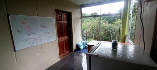 PoásにあるEpimoniの白い板の壁と窓が備わる客室です。