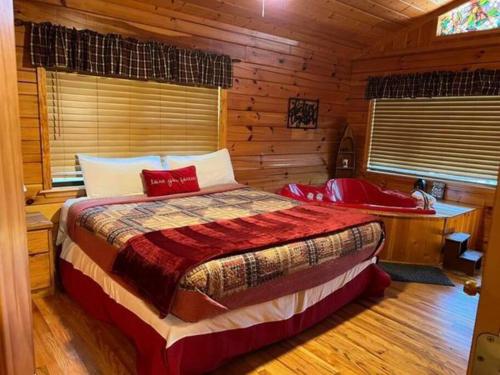 a bedroom with a bed in a log cabin at Beary Tale! Your happily ever after starts here! in Sevierville