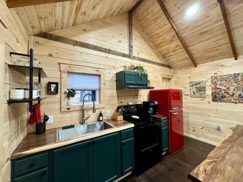 a kitchen with a red refrigerator and a sink at Brook Haven Retreat - Minutes to Mt Snow / Stratton, Pet Friendly! in Wardsboro