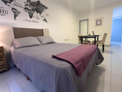 a bedroom with a large bed and a table at Departamento en San Luis in San Luis