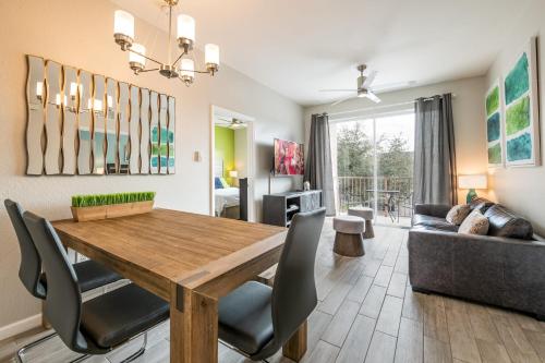 a dining room and living room with a wooden table and chairs at Near Pool*Balcony*VistaCay Convention Ctr & Idrive in Orlando