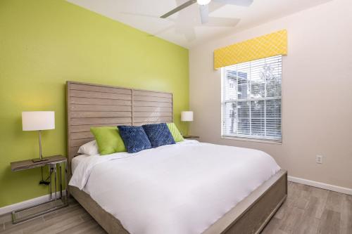 a bedroom with a large white bed and a window at Near Pool*Balcony*VistaCay Convention Ctr & Idrive in Orlando