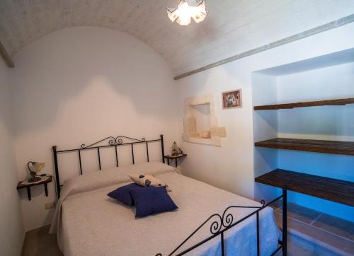 a bedroom with a bed with a teddy bear on it at Trullo Mont Bell con giardino e piscina privata in Selva di Fasano